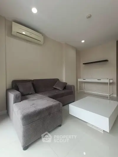 Modern living room with sleek furniture and air conditioning in a stylish apartment.