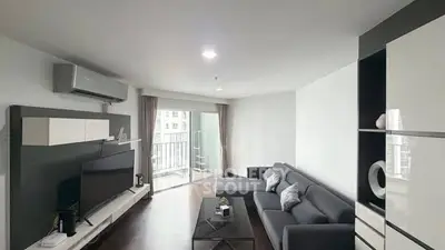 Modern living room with sleek furniture and balcony access in a stylish apartment.