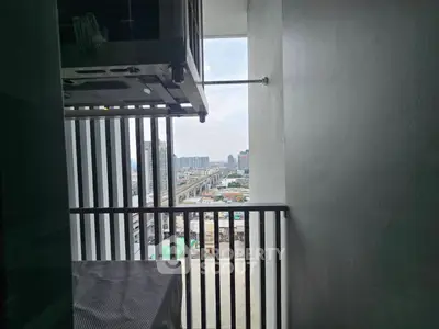 Urban balcony with city view, showcasing modern high-rise living and expansive skyline.