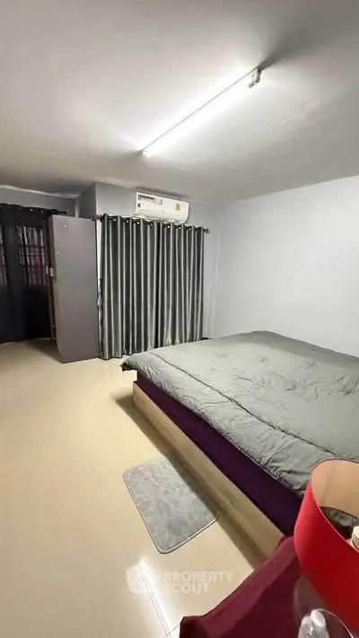 Cozy bedroom with modern decor and ample natural light