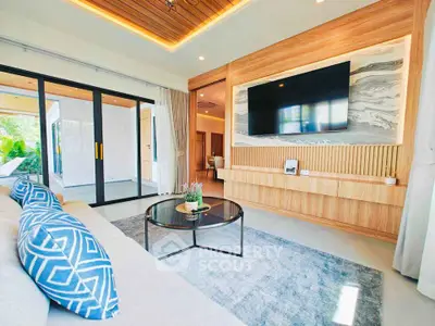 Luxurious modern living room with stylish decor and large TV, perfect for relaxation.