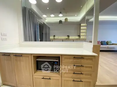 Modern kitchen with microwave and stylish cabinetry in open layout apartment
