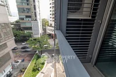 Modern urban balcony with city view and sleek architectural design.
