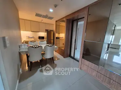 Modern dining area with elegant chairs and sleek kitchen in open layout