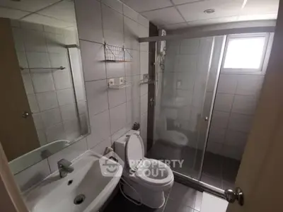 Modern bathroom with sleek tiles and glass shower enclosure