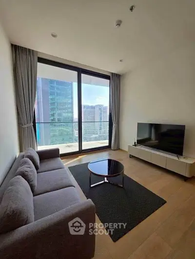 Modern living room with large window and city view, featuring a sleek sofa and TV setup.