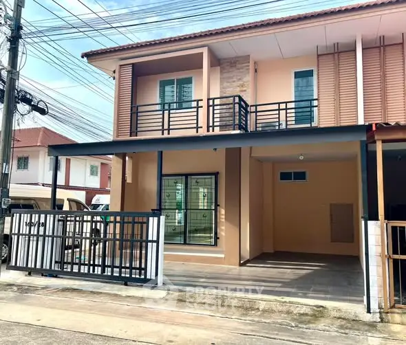 Charming two-story house with modern balcony and spacious driveway in a serene neighborhood.