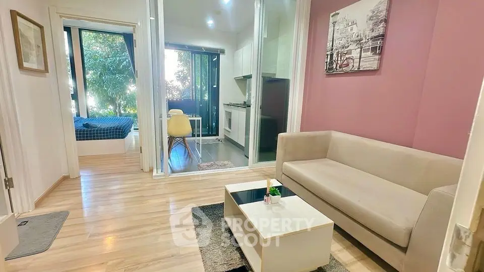 Modern apartment with open layout, cozy living room, and stylish kitchen near bedroom.