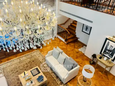 Luxurious living room with elegant chandelier and stylish decor in a spacious open layout.