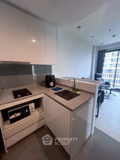 Modern kitchen with sleek cabinetry and integrated appliances in a stylish apartment.
