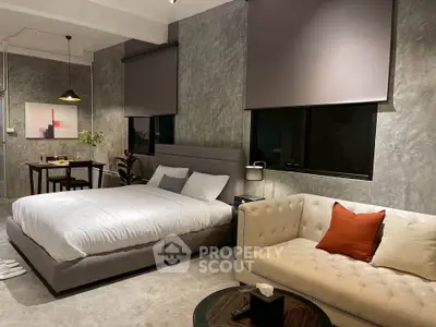 Modern bedroom with stylish decor and cozy seating area, perfect for relaxation and comfort.