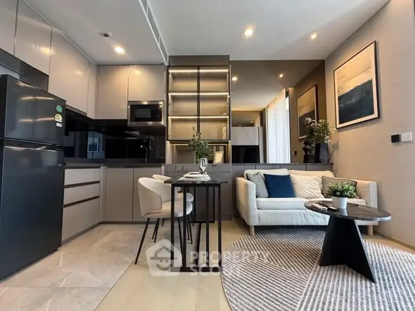 Modern open-layout kitchen and living room with sleek design and cozy seating area.