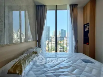 Modern bedroom with city view, large windows, and stylish decor in urban apartment.
