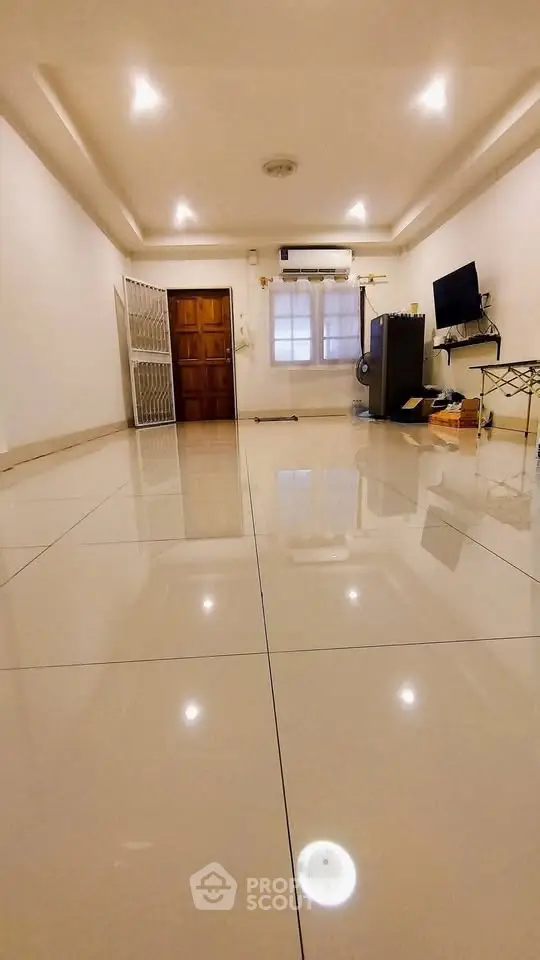 Spacious living room with glossy tiled floors and modern decor