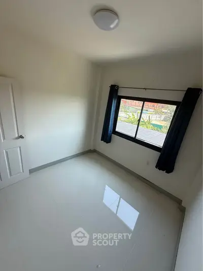 Bright empty room with large window and glossy white floor tiles