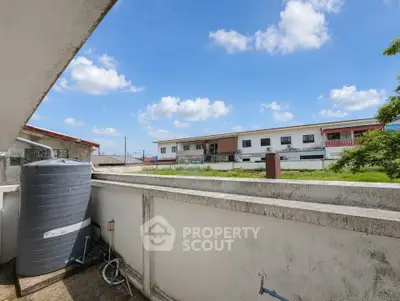 Spacious balcony with scenic view of residential neighborhood and clear blue sky.
