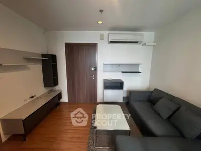 Modern living room with sleek furniture and air conditioning, perfect for comfortable urban living.