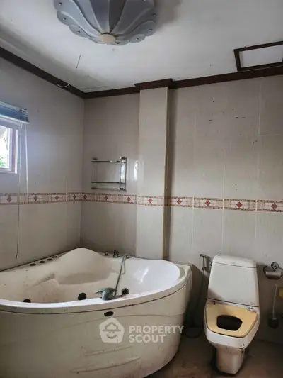 Spacious bathroom with corner bathtub and natural light