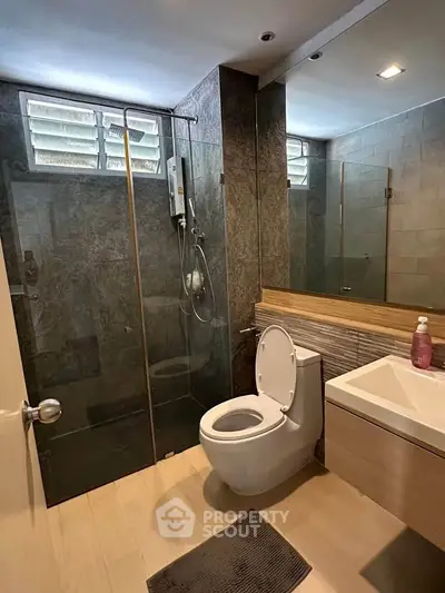 Modern bathroom with glass shower and sleek fixtures