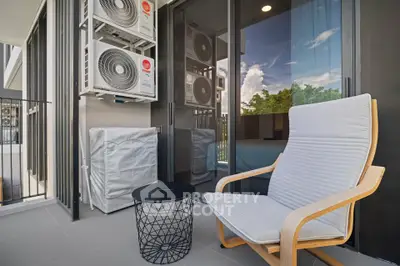 Modern balcony with comfortable seating and air conditioning units, perfect for relaxation.