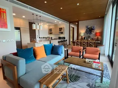 Spacious modern living room with vibrant decor and open kitchen layout.