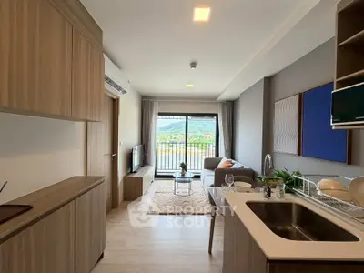 Modern open-plan living room with kitchen and balcony view