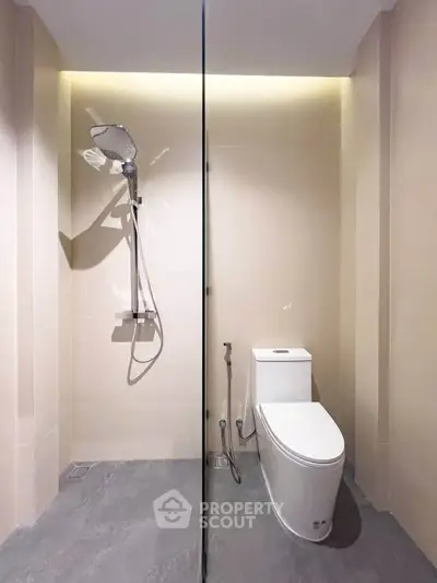 Modern bathroom with sleek shower and toilet in minimalist design