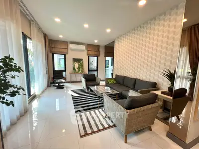 Spacious modern living room with stylish decor and large windows for natural light.