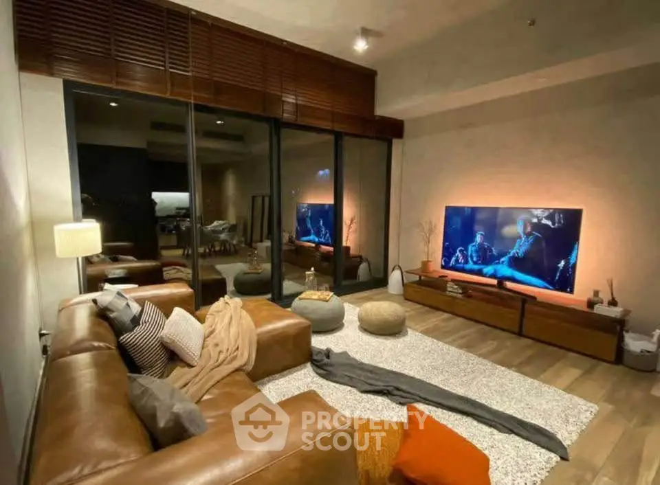 Luxurious living room with leather sofas, large TV, and modern decor for ultimate comfort and style.
