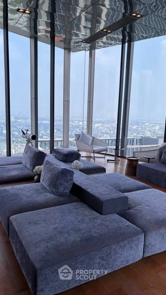 Luxurious high-rise living room with panoramic city views and modern furnishings.