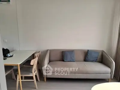 Cozy living room with modern sofa and dining table setup