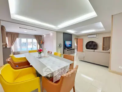 Spacious modern living and dining area with stylish furniture and ample natural light.