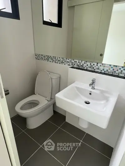 Modern bathroom with sleek fixtures and stylish tile accents.