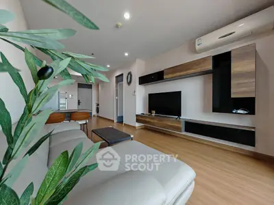 Modern living room with sleek furniture and air conditioning, featuring a stylish entertainment center.