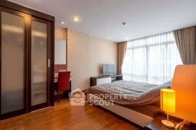 Spacious modern bedroom with elegant decor and natural light