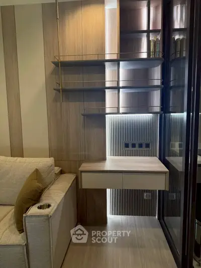 Modern living room with sleek wooden shelves and built-in desk, perfect for stylish urban living.