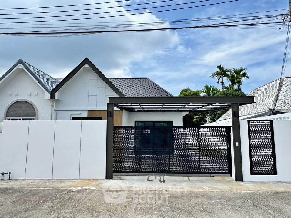 Charming modern house exterior with sleek gate and lush greenery, perfect for family living.