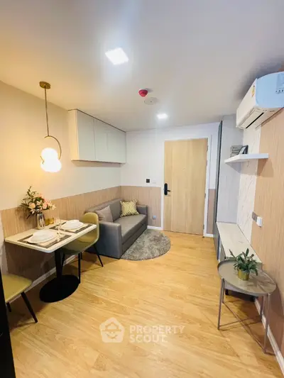 Modern living room with stylish decor and cozy dining area in a contemporary apartment.