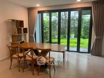 Spacious dining area with garden view and elegant wooden furniture