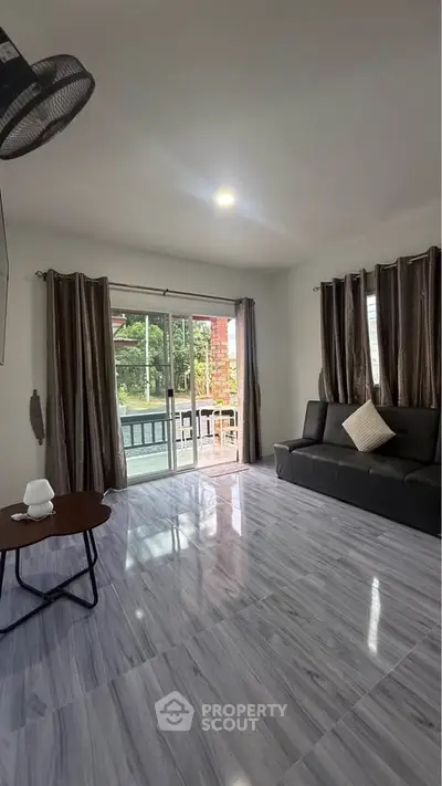 Spacious living room with modern decor and large windows for natural light.