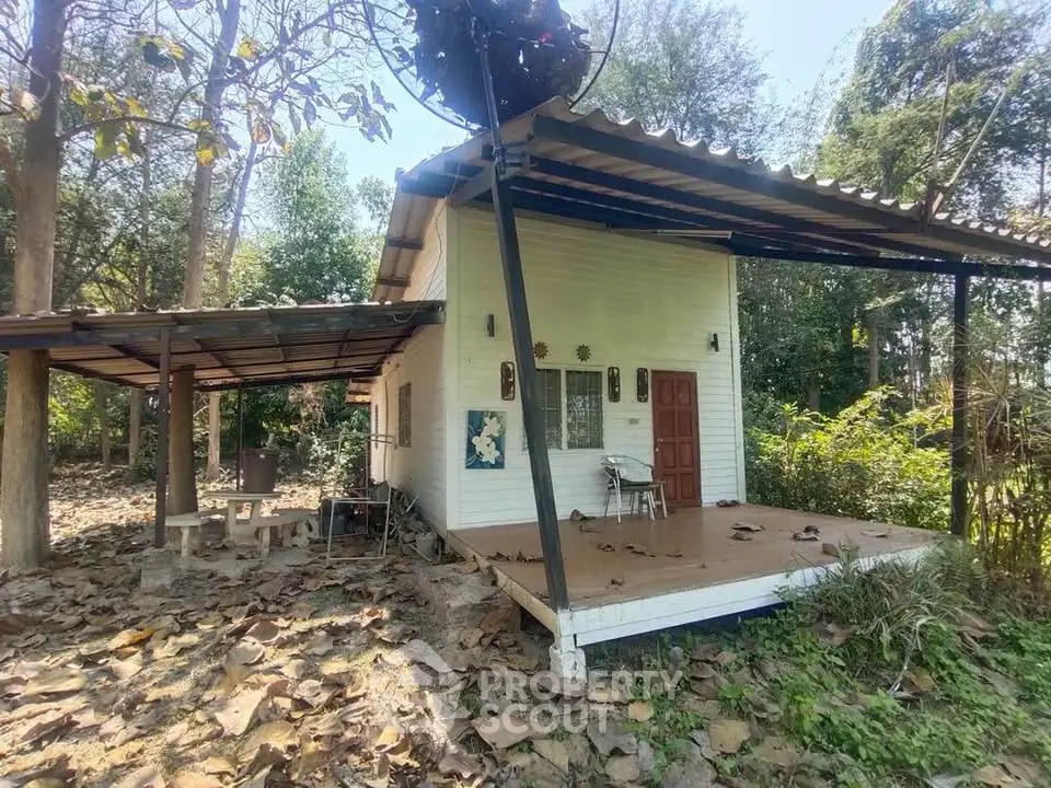 Charming small house with rustic porch in a serene wooded setting