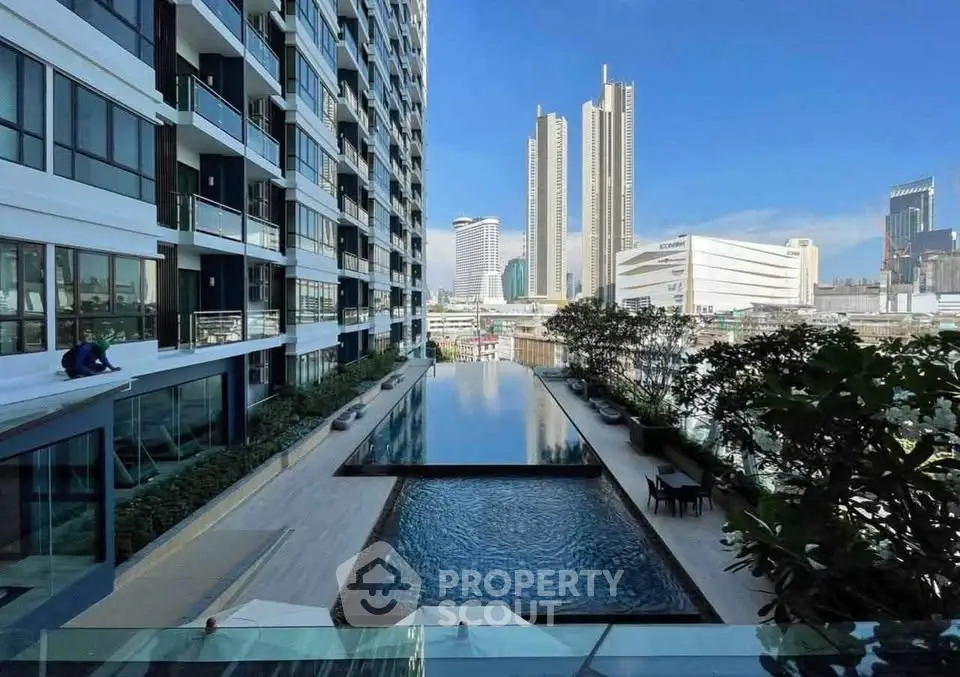 Luxurious high-rise apartment with stunning city view and infinity pool, perfect for urban living.