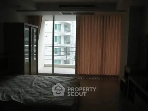 Spacious bedroom with balcony access in modern apartment