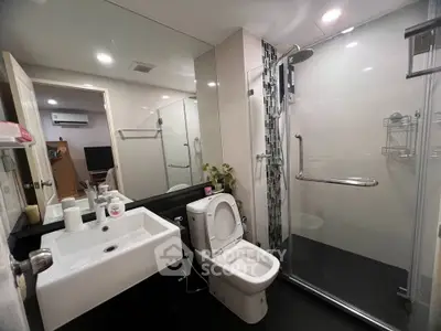 Modern bathroom with sleek design, glass shower, and contemporary fixtures in a stylish apartment.