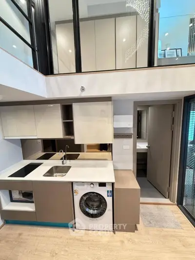 Modern duplex kitchen with built-in appliances and washing machine