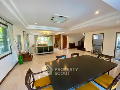 Spacious open-plan living and dining area with modern furnishings and ample natural light.