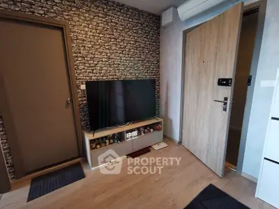 Modern living room with stylish brick accent wall and sleek wooden flooring
