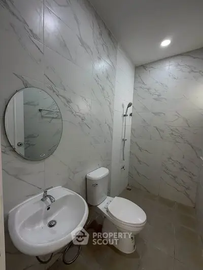 Modern bathroom with marble tiles and sleek fixtures