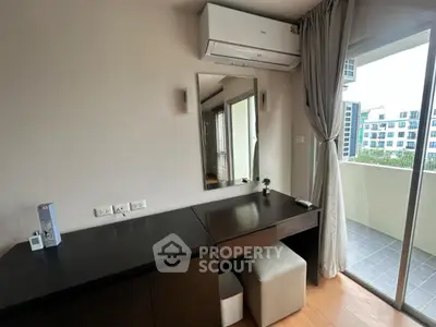 Modern bedroom with balcony access and sleek furniture in urban apartment