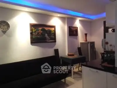 Modern living room with ambient lighting, stylish decor, and compact dining area.